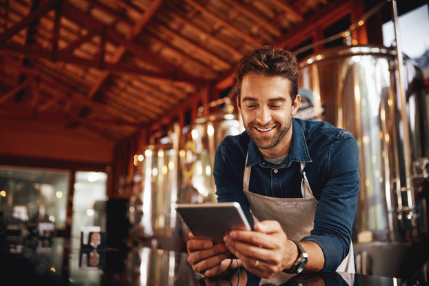 male business owner looking at tablet