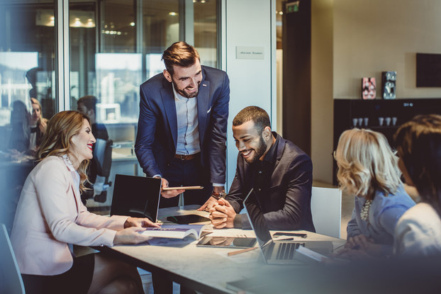 group of employees working at a table in office