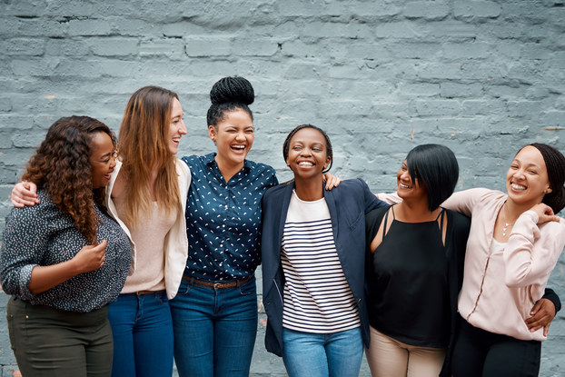 group of friends standing with their arms around each other