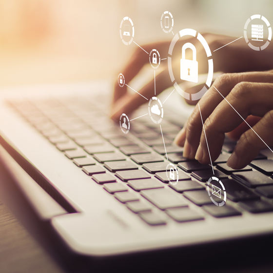 hands on a laptop with image of a padlock