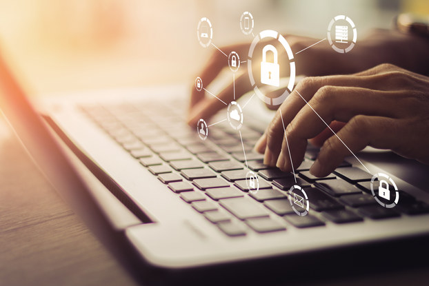 hands on a laptop with image of a padlock