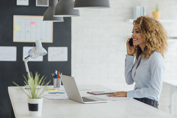 woman working in office on phone