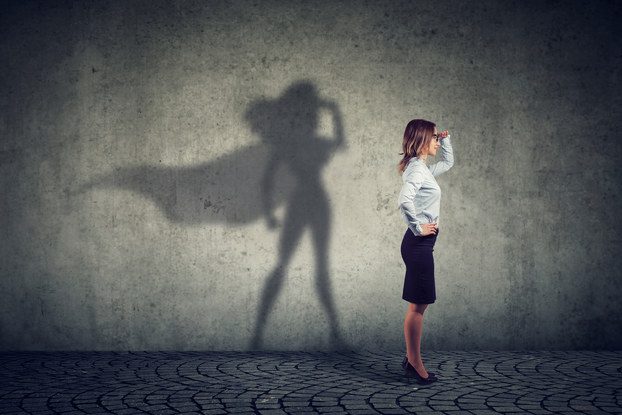 woman standing with superhero shadow