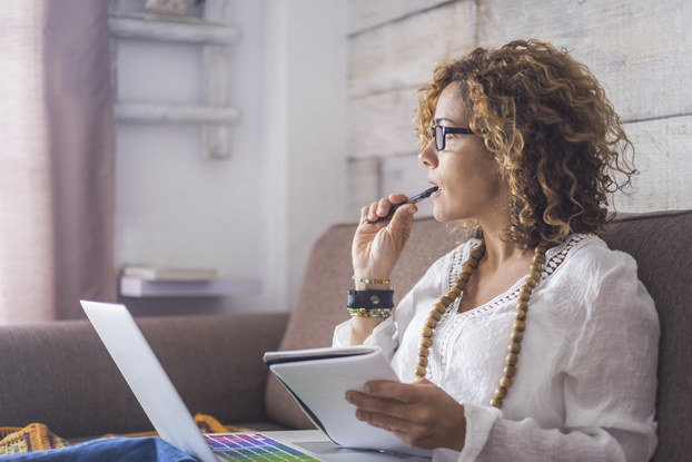 woman sitting on couch thinking