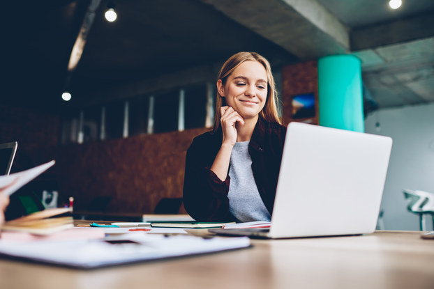 woman smiling at laptop