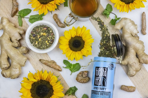 container of tiesta tea loose tea displayed with herbs and flowers