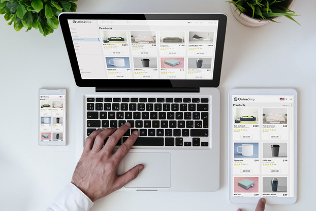 screens of laptop, phone and tablet open to online shopping website