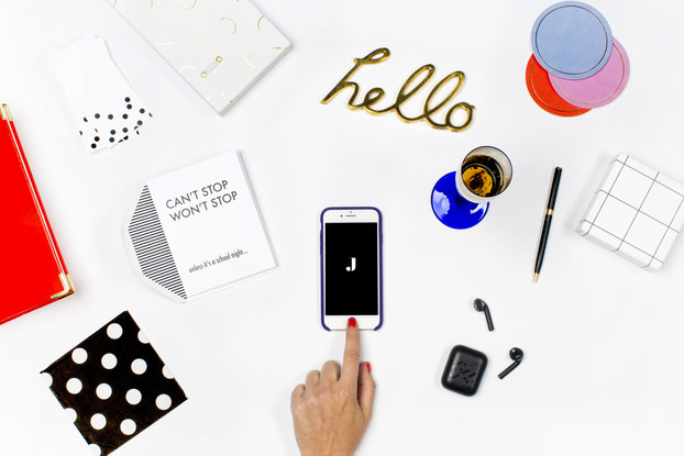 jetblack's branding spread on a white desk with phone