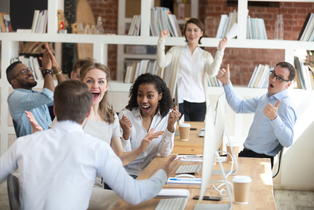 group of coworkers receiving good news