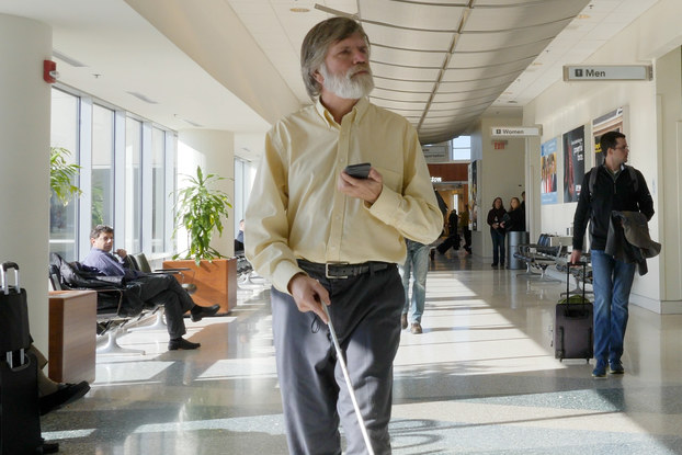 man with cane using indoor explorer app