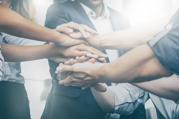 employees stacking their hands in a circle