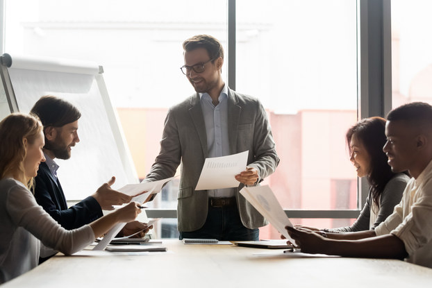 group of employees at table in a meeting