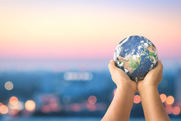 hands holding a small globe