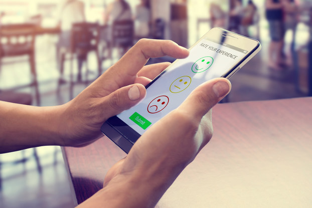 person rating a website on a tablet