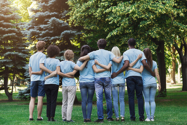 group of volunteers with their arms around each other