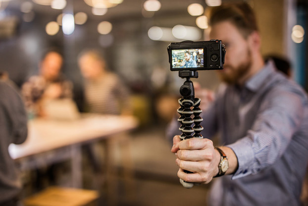 Man holding phone recording himself