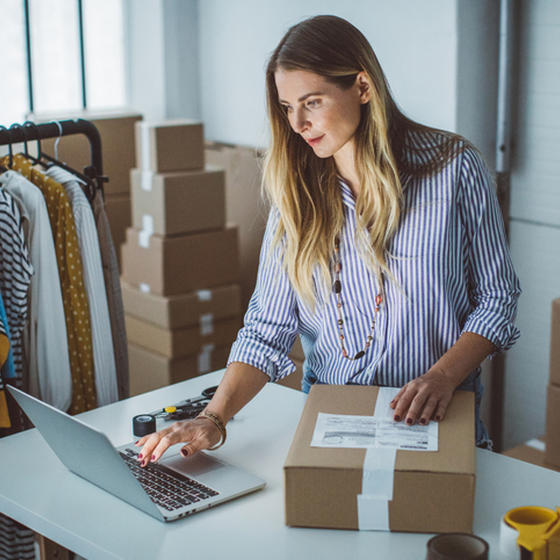 Woman preparing box for shipping
