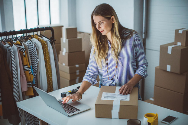 Woman preparing box for shipping