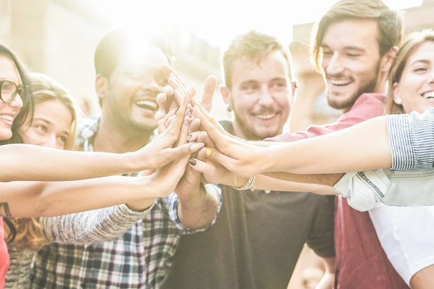 group of young professionals high-fiving