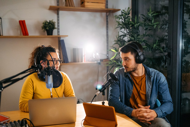 two people recording a podcast