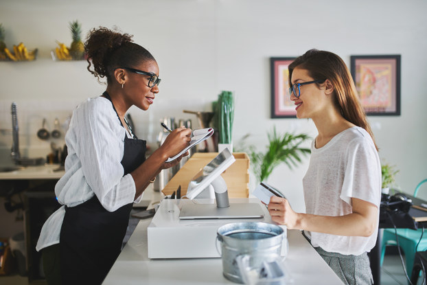customer at cafe placing order with employee