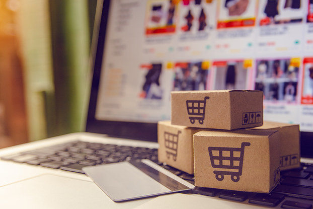 little boxes with shopping carts sitting on top of a laptop keyboard