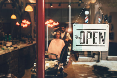  open sign in barber shop window 