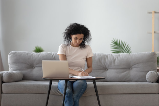 Woman works on document while working from home