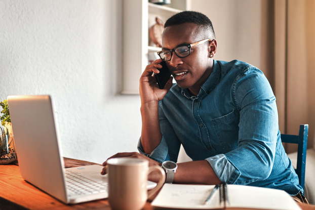 Man uses communication platforms to work from home.