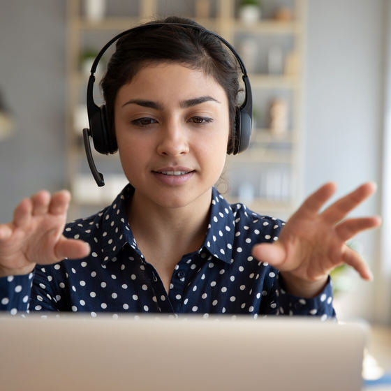 woman on laptop with headset