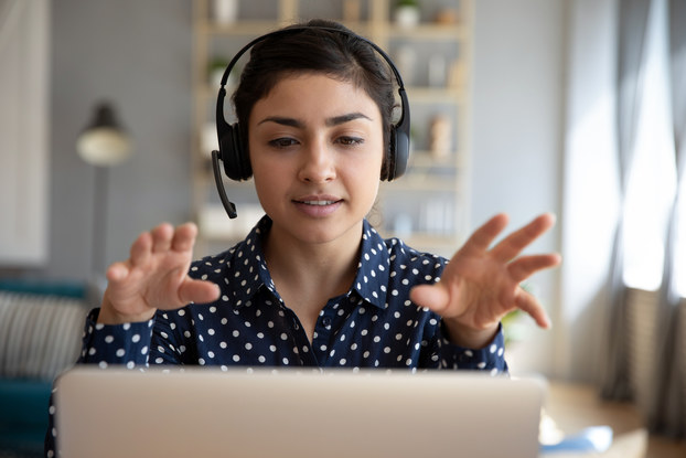 woman on laptop with headset