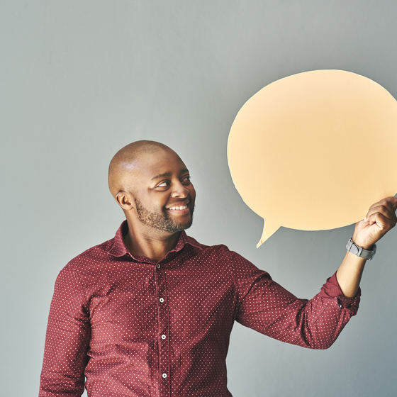 man holding speech bubble cutout