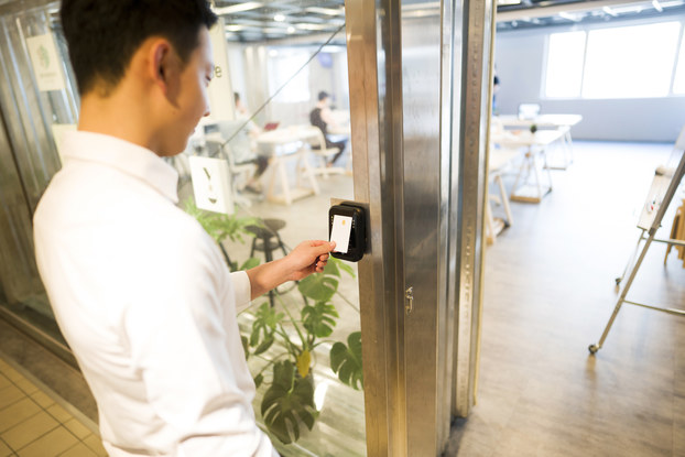 man using key card to access office