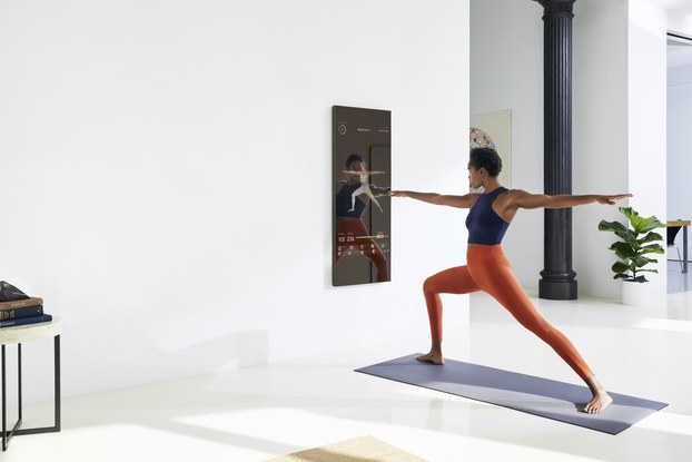 woman using mirror for home exercise