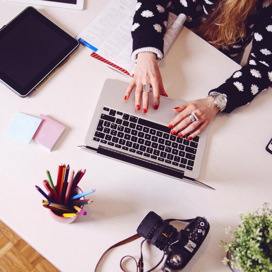 woman typing on laptop at desk