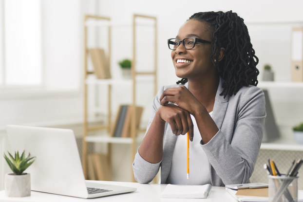woman sitting at desk smiling