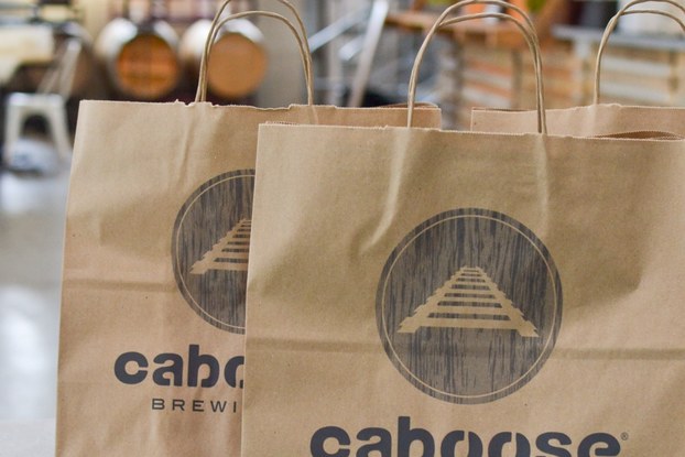 bags with caboose brewing co. branding