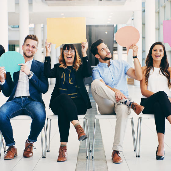 group of young professionals holding speech bubbles