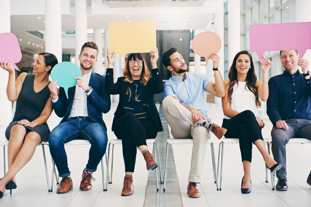 group of young professionals holding speech bubbles