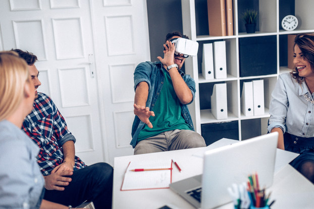group of young professionals testing a VR headset