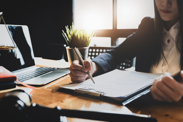woman sitting at desk doing paperwork