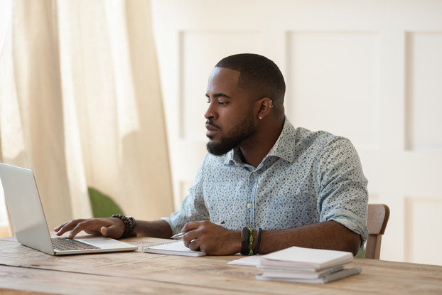 man working on laptop at desk
