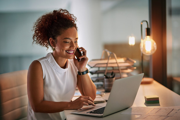 woman working on her phone and laptop