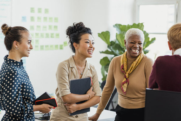 Group of coworkers has discussion in inclusive environment.