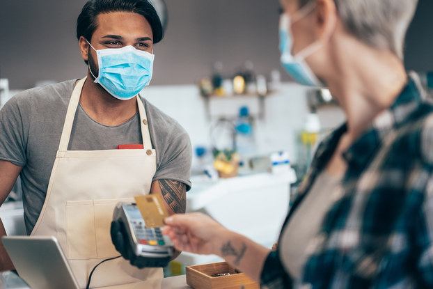 Customer pays for product during COVID-19 pandemic.