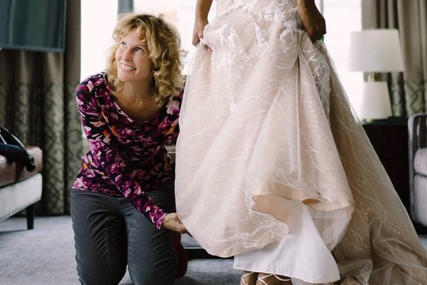 Luba Gankin of primavera dreams touching a wedding dress