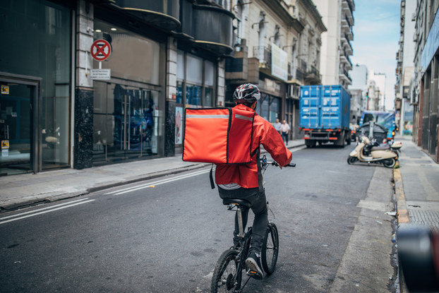 man delivering food on bicycle