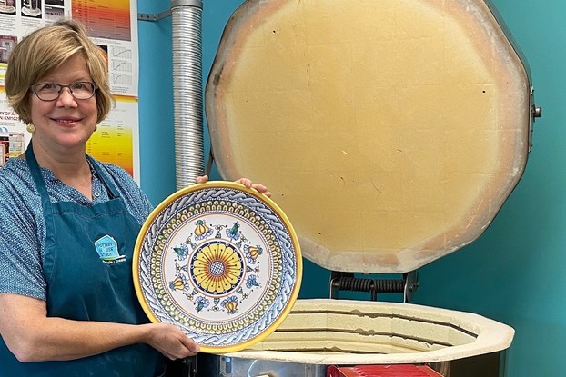 Susan Snyder of Pottery House holding bowl