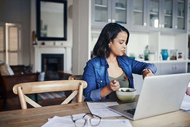 woman working from home checking her watch