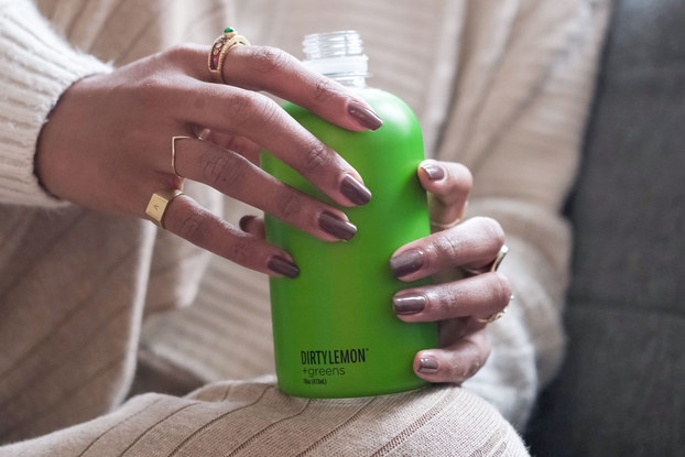 woman holding dirty lemon beverage